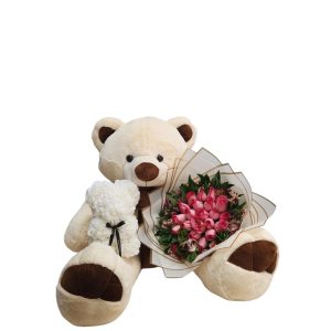 Oso de peluche con buchón de rosas y astromelias, acompañado de un oso de fomi blanco.